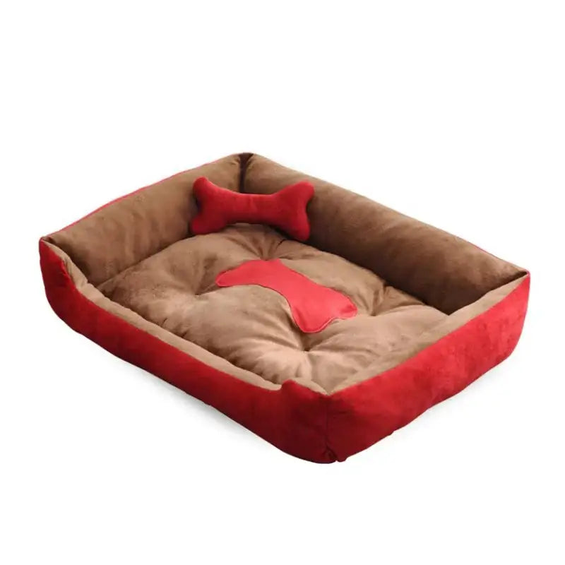 Plush rectangular pet bed with red trim and a bone-shaped pillow.