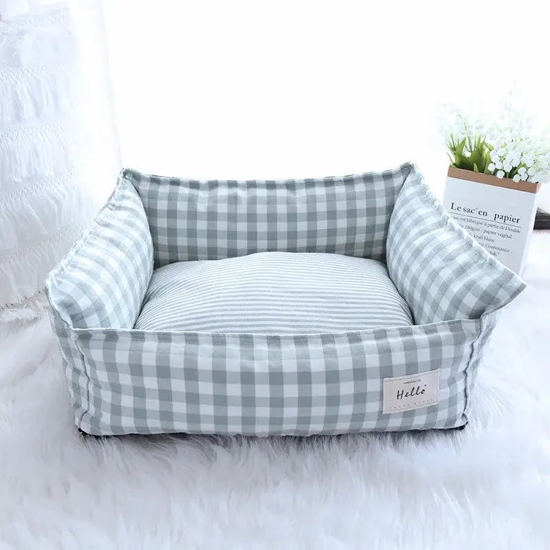 Plaid patterned pet bed with cushioned sides and a soft interior.