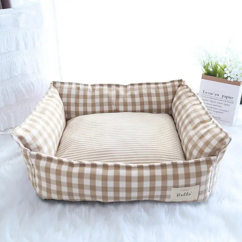 Plaid-patterned pet bed with a striped cushion.