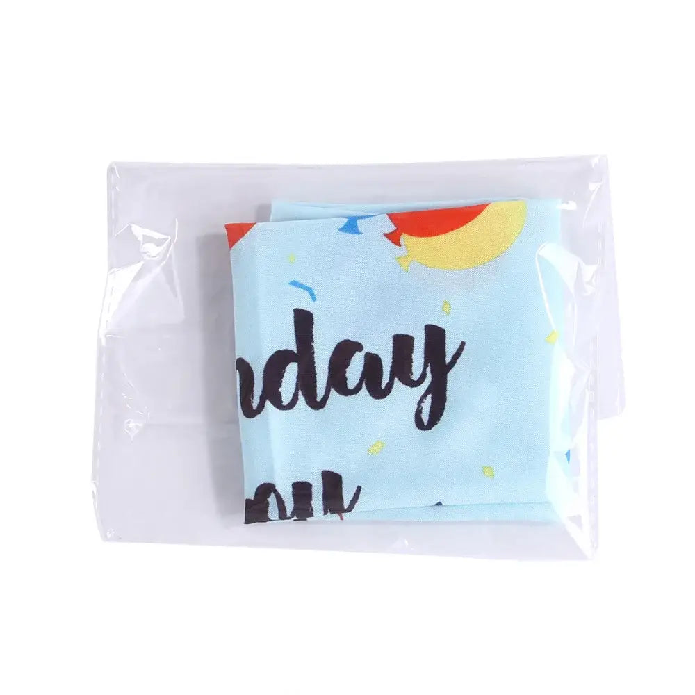 Folded light blue fabric with partial text visible, sealed in a clear plastic bag.