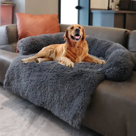 Golden Retriever dog lying comfortably on a plush gray pet bed.