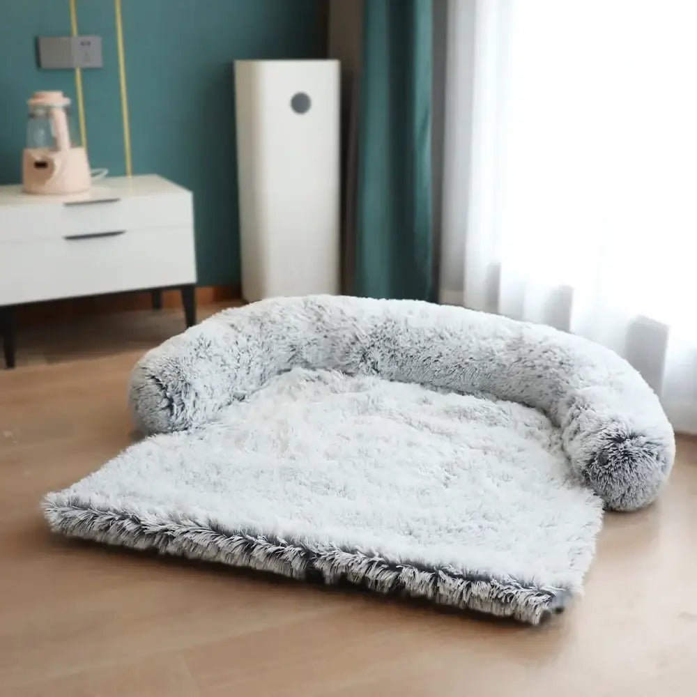 Plush, curved pet bed with a soft, fluffy gray border and white interior cushion.