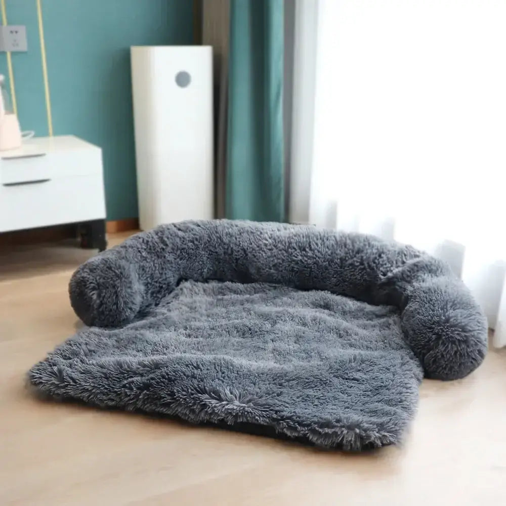 Plush, fluffy gray pet bed with raised sides and a flat cushioned center.