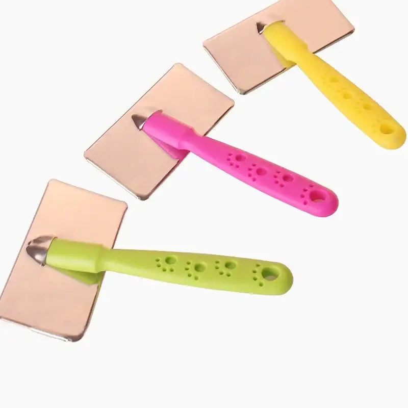 Colorful plastic ice cream scoop-shaped utensils with paw print designs on their handles.