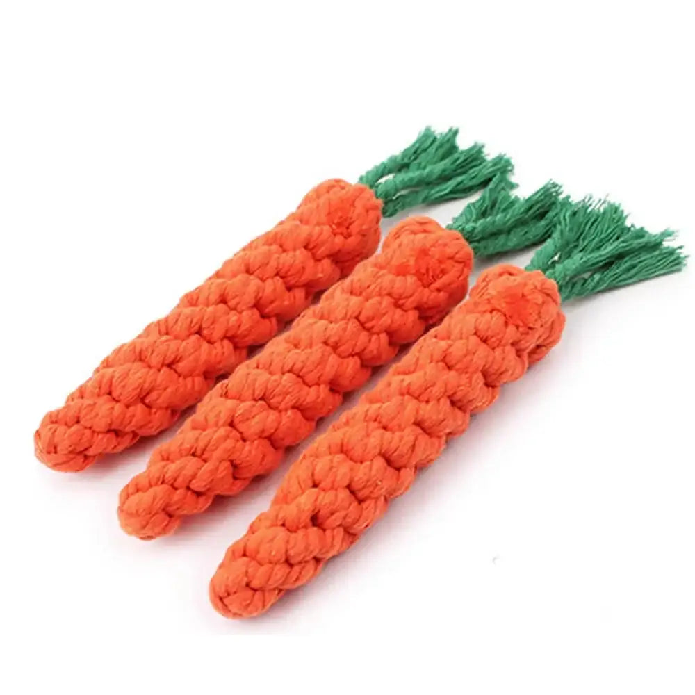 Knitted or crocheted carrot-shaped dog toys with orange bodies and green leafy tops.