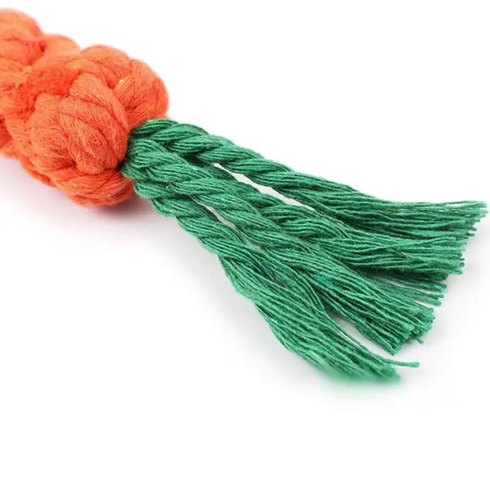 Yarn tassel with orange pom-pom top and green fringe bottom.