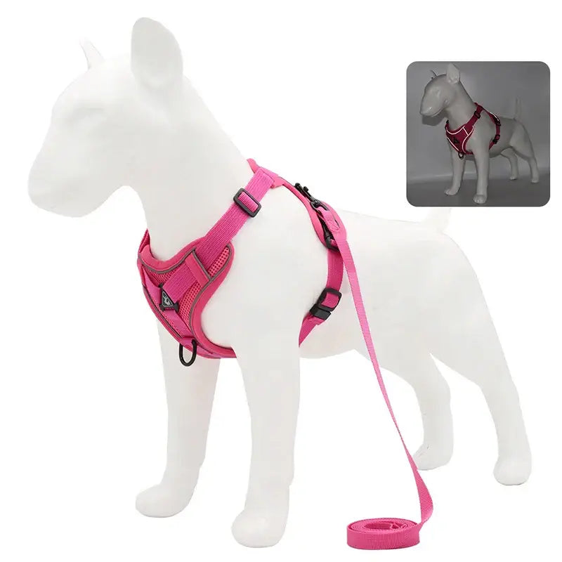 Pink dog harness with attached leash on a white dog-shaped mannequin.