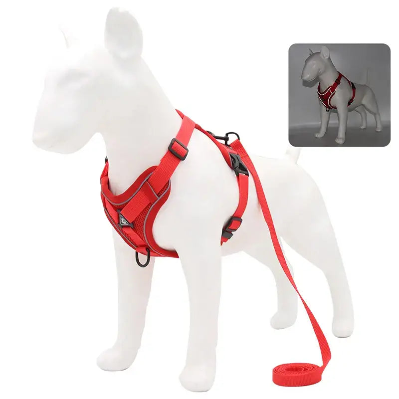 Red dog harness with attached leash on a white dog mannequin.