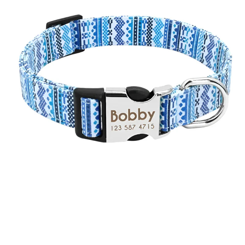 Dog collar with a blue patterned design and personalized name tag.