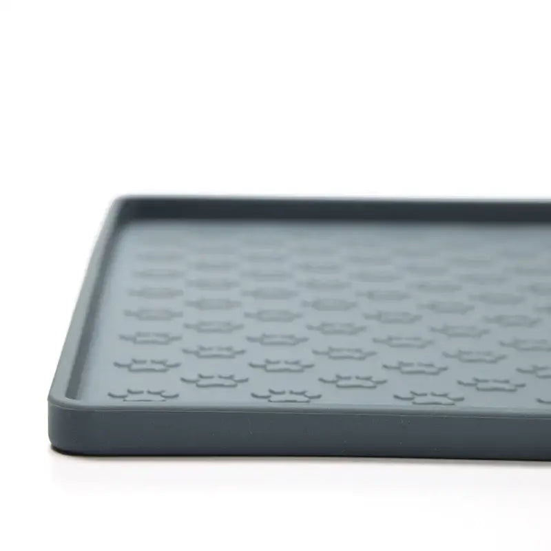 Gray silicone mat with raised hexagonal pattern.