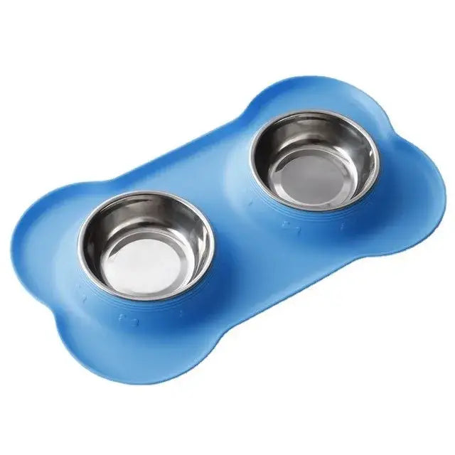 Blue bone-shaped pet feeding mat with two stainless steel bowls.