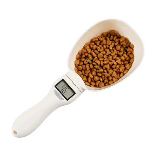 Digital measuring scoop filled with dry pet food kibble.