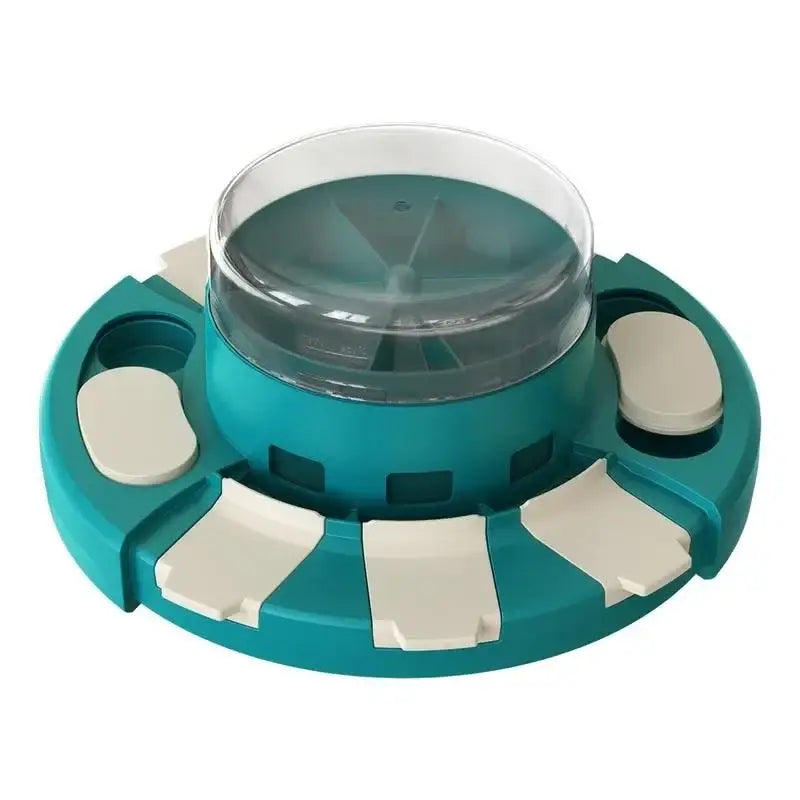 Teal-colored circular device with a clear dome top and white rectangular attachments around its perimeter.