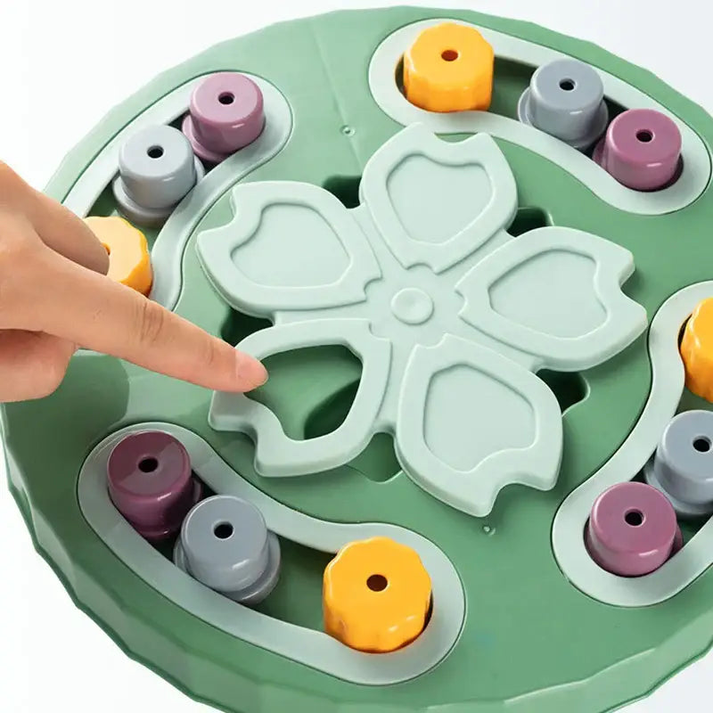 Circular green puzzle toy with a flower-shaped center and colorful cylindrical pieces around the edges.