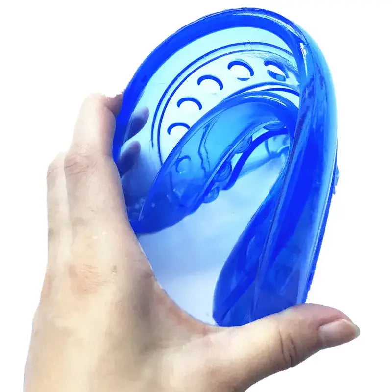 Blue plastic mouthguard or dental appliance held in a hand.