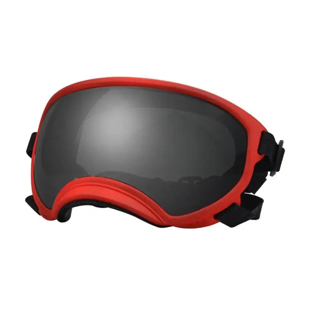 Red-framed ski goggles with dark tinted lenses.