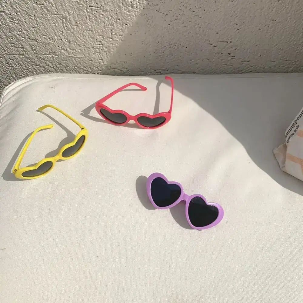 Three pairs of colorful sunglasses in different styles.