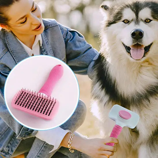 Dog grooming brush with a pink handle and metal bristles.