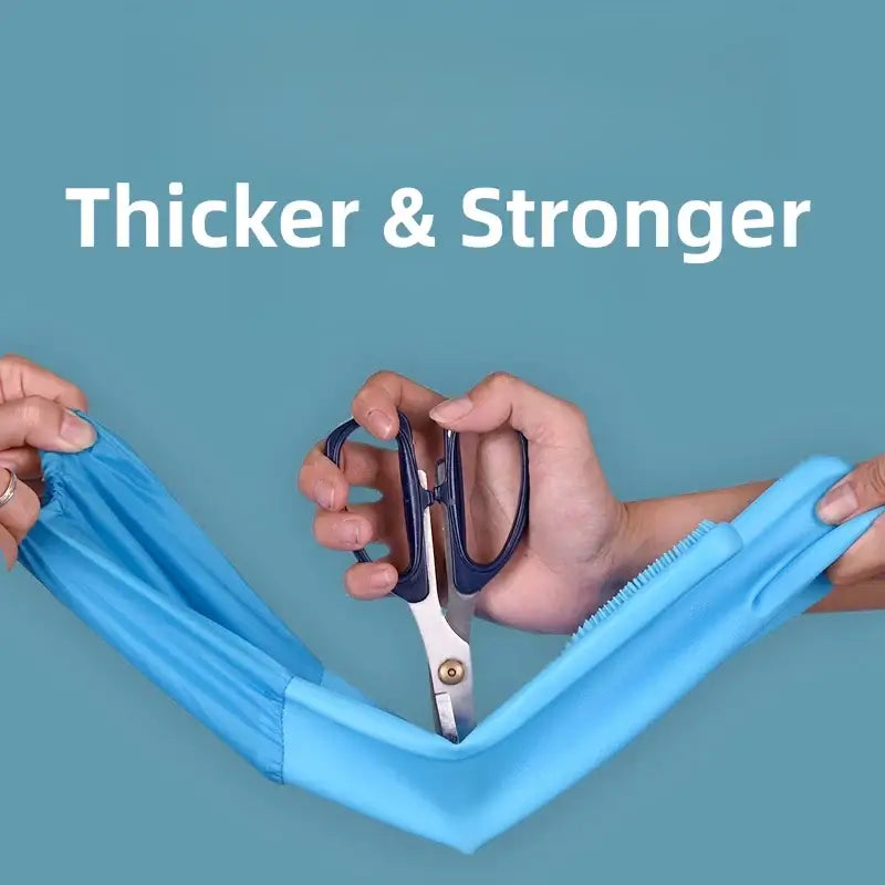 Pair of scissors cutting through a blue fabric or material.