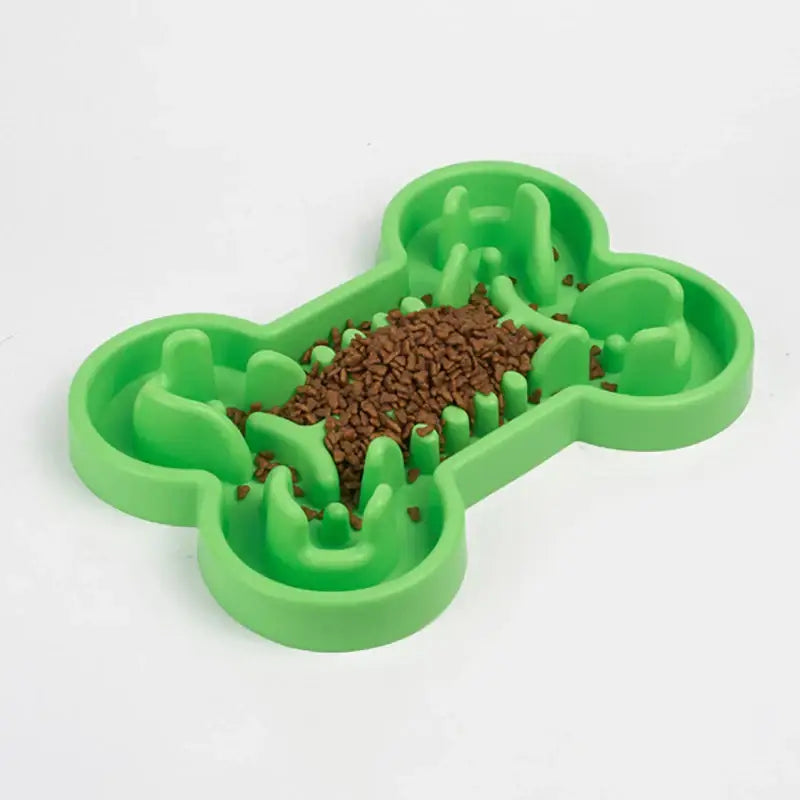 Bone-shaped green plastic dog food bowl filled with kibble.