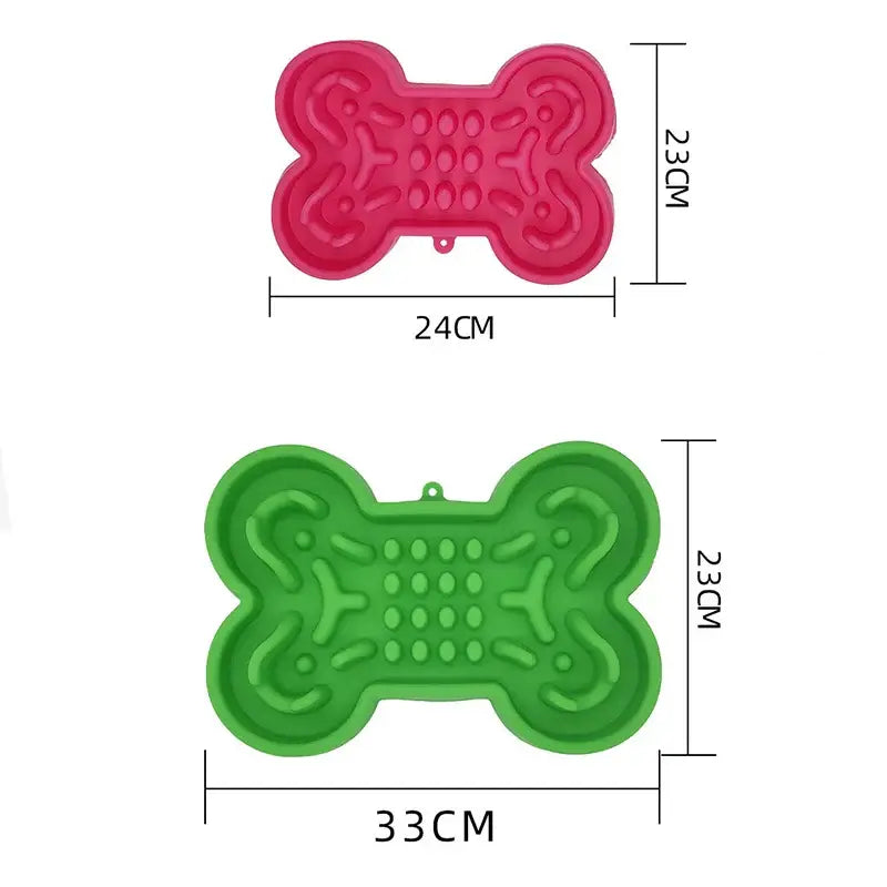 Bone-shaped silicone molds or lick mats in pink and green colors.