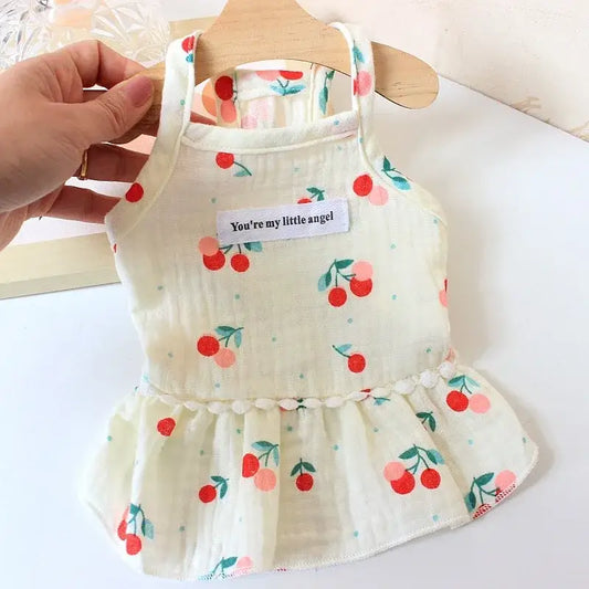 Cream-colored dog dress with cherry print and a ruffled skirt, featuring a ’You’re my little angel’ tag.