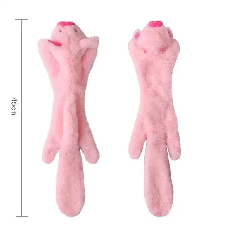 Pink plush toy shaped like a stretched-out animal with long limbs and a tail.