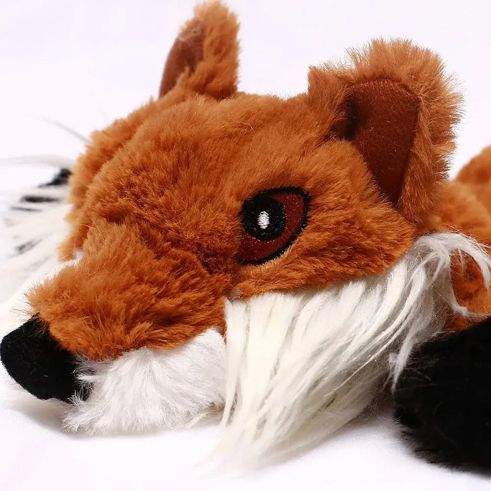 Plush toy fox with a fluffy orange body and white muzzle.