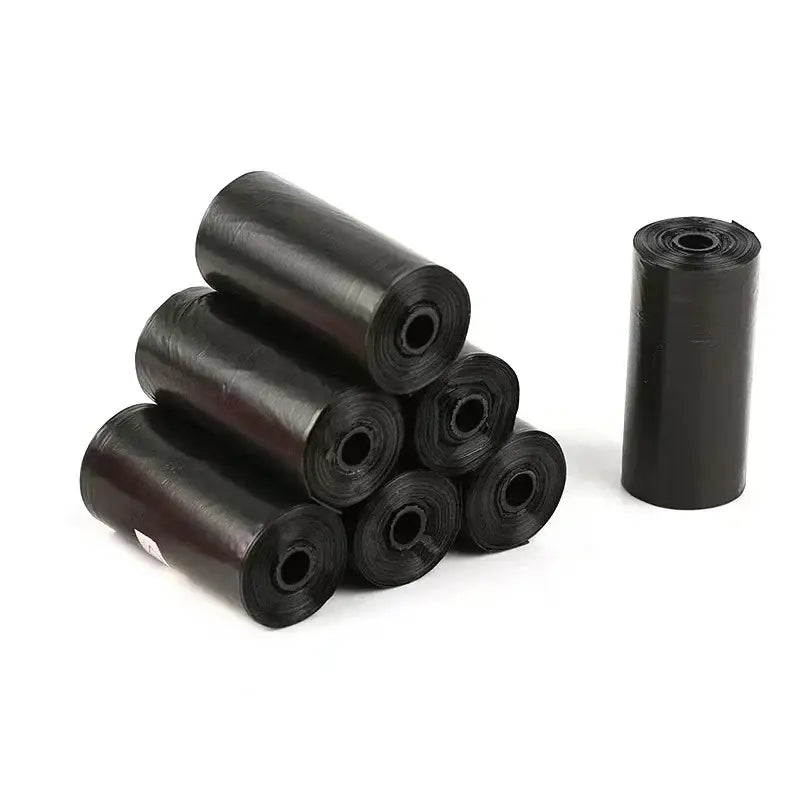 Black cylindrical plastic waste bags or dog poop bags rolled up.