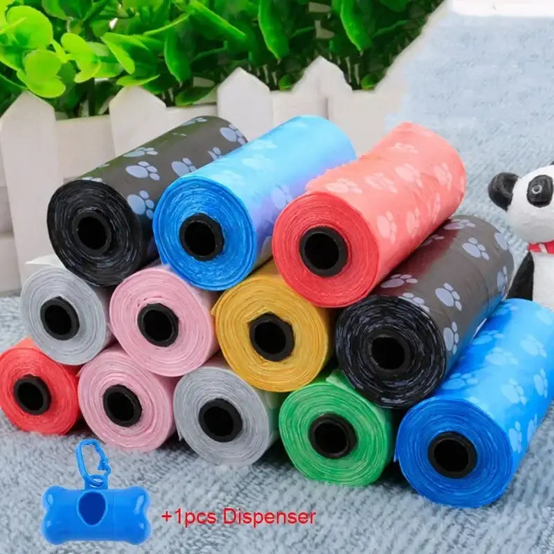 Colorful rolls of plastic dog waste bags with a blue dispenser.