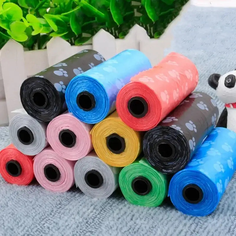 Colorful rolls of plastic waste bags or dog poop bags in various hues.