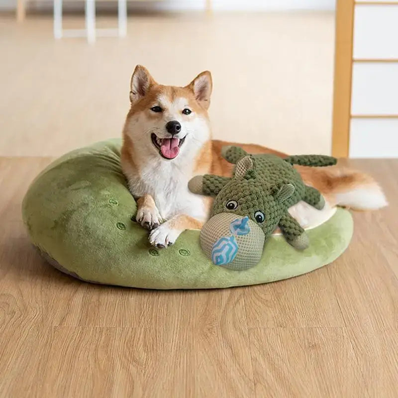 Smiling Shiba Inu dog lying on a green cushion with plush toys.