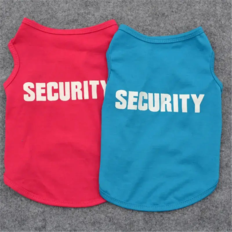 Two dog vests with ’SECURITY’ printed on them in white letters, one red and one blue.