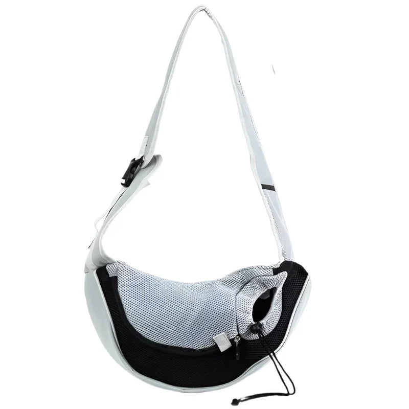 Pet carrier sling bag with mesh panel and adjustable strap.