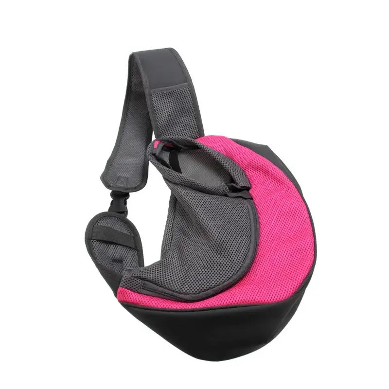 Pink and black pet carrier sling with a shoulder strap.