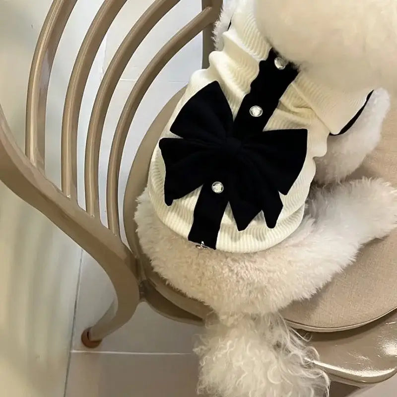 Plush white cat toy with a black bow decoration.