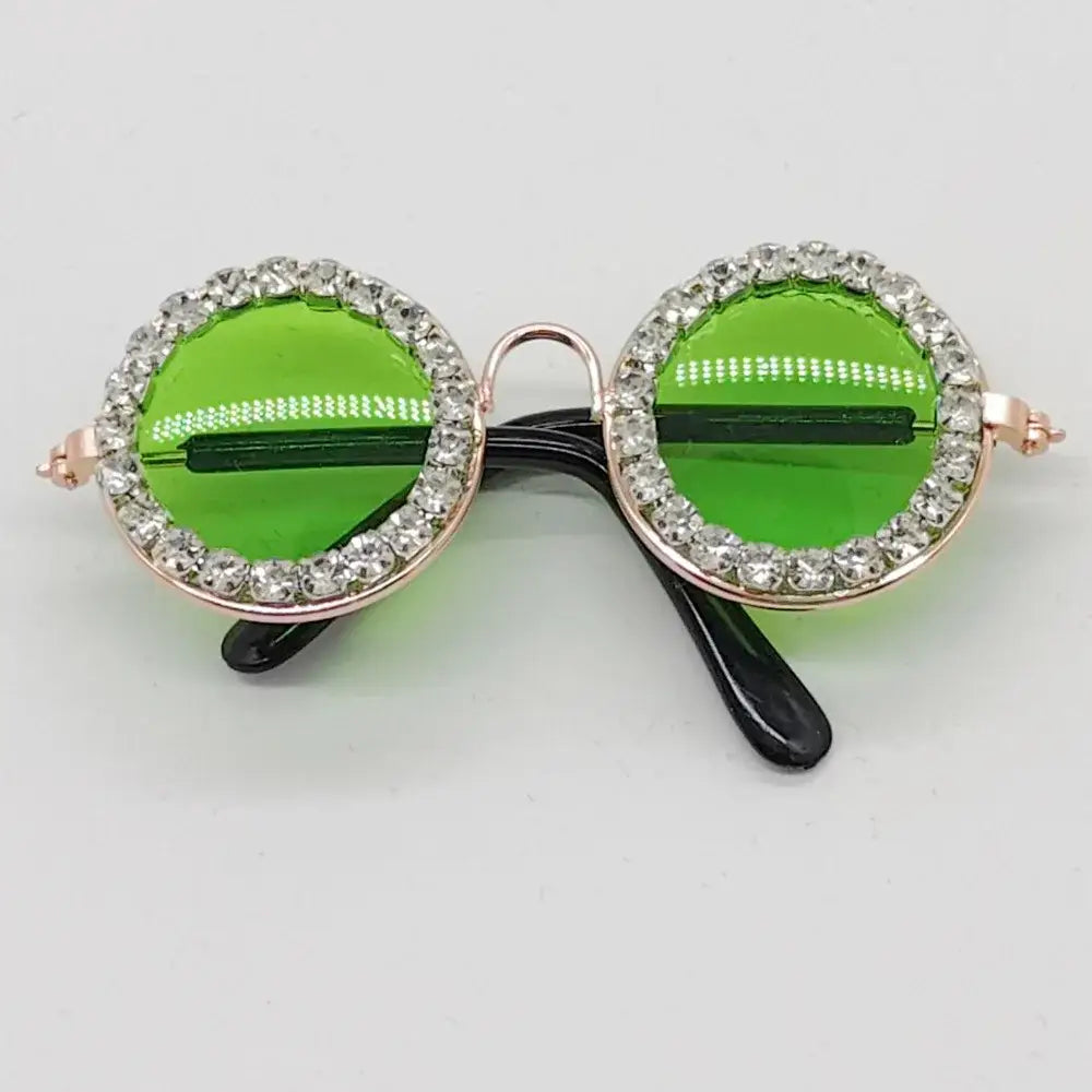 Pair of round green sunglasses with rhinestone-encrusted frames.