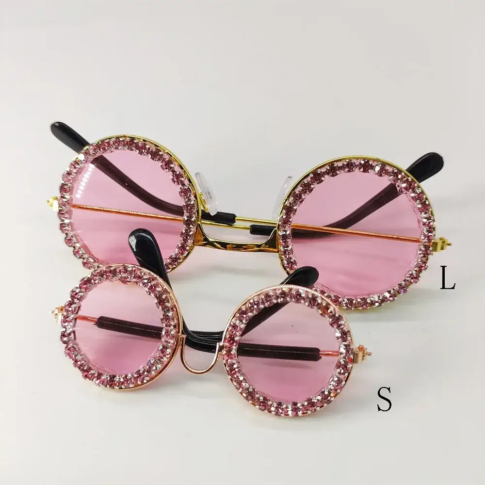 Pair of round, pink-lensed sunglasses with rhinestone-encrusted frames.