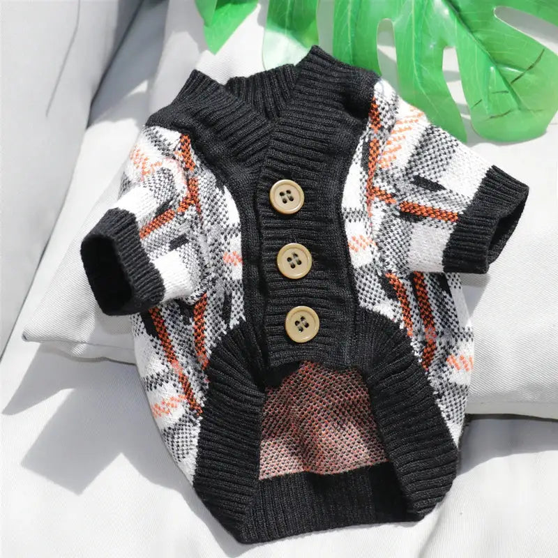 Knitted dog sweater with a plaid pattern and button-up front.