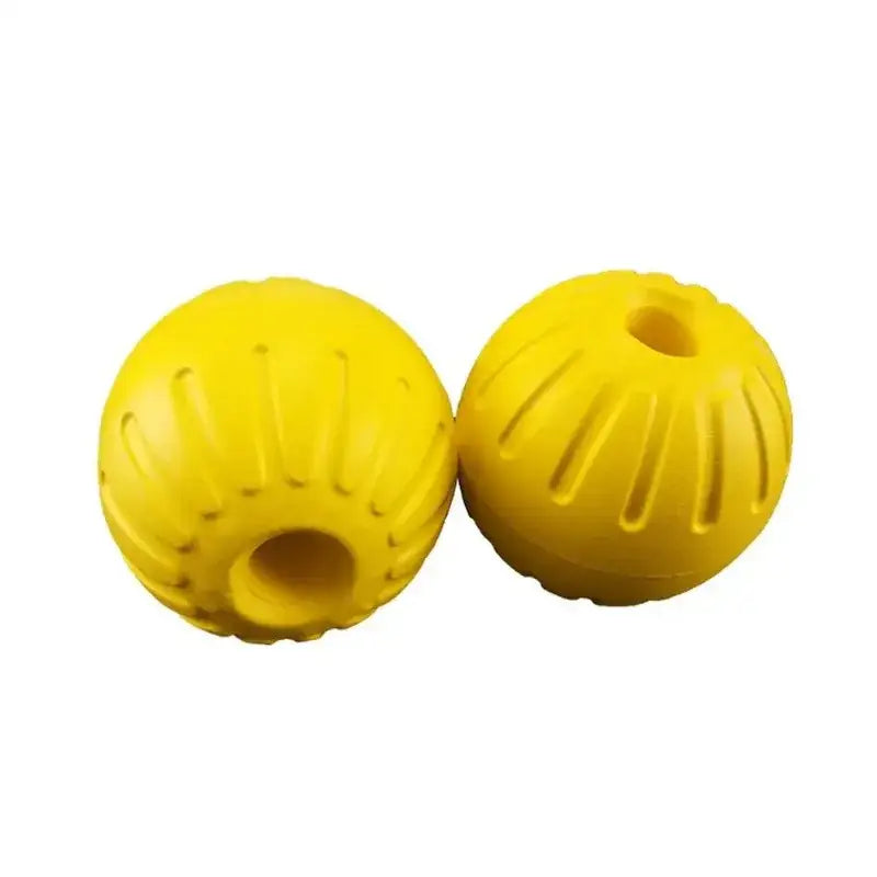 Two bright yellow rubber balls with ridged patterns and holes.