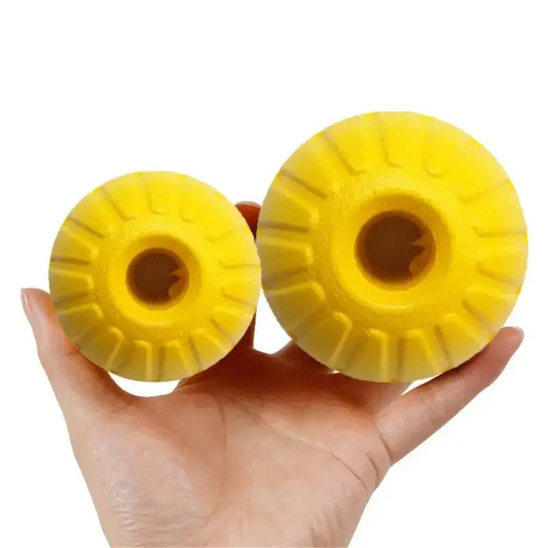 Two bright yellow rubber dog toys with ridged edges and hollow centers.