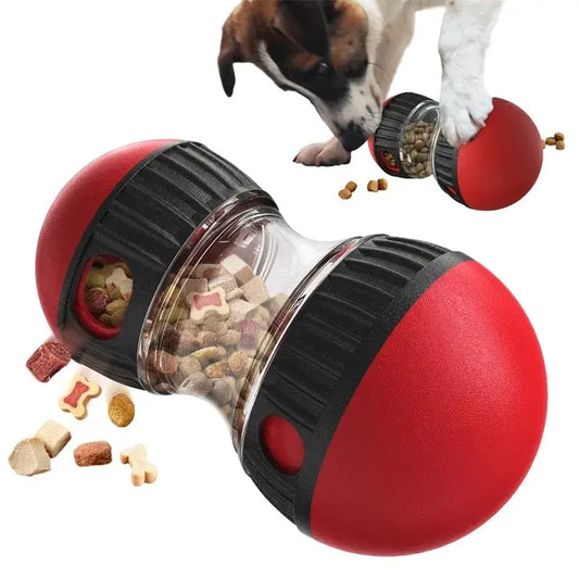 Dog treat dispenser toy shaped like a red and black capsule with a transparent middle section.