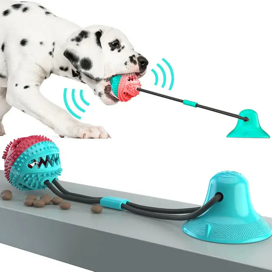 Interactive dog toy with a suction cup base, tug rope, and textured ball.