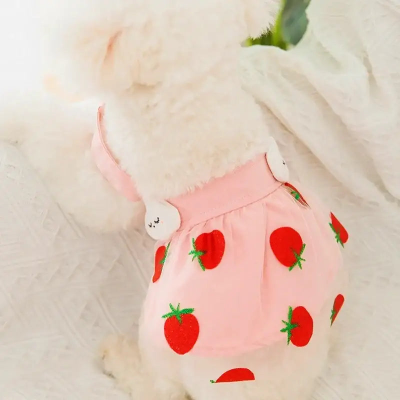 Pink strawberry-patterned underwear or diaper on a fluffy white surface.