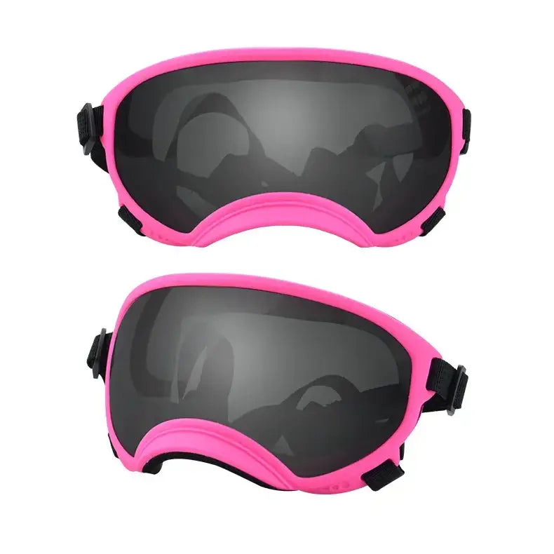 Pink-framed ski goggles with dark lenses.