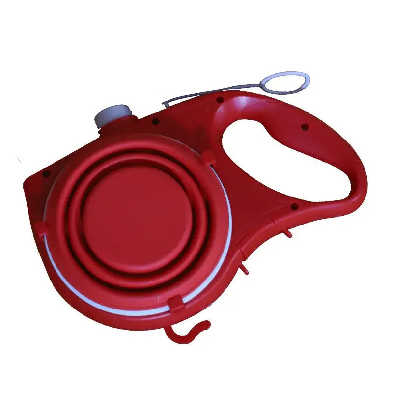 Retractable red dog leash with a circular housing and handle.