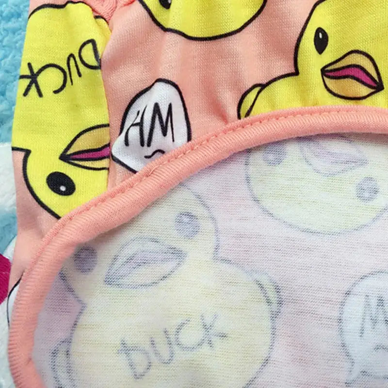 Colorful fabric with duck and text patterns.