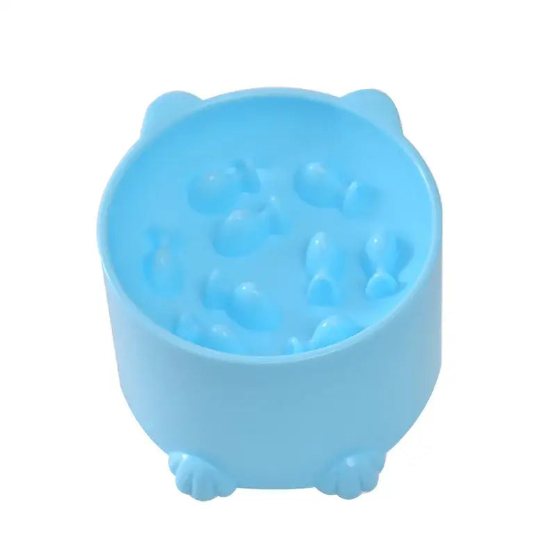 Light blue plastic pet bowl with paw print designs inside and small feet on the bottom.