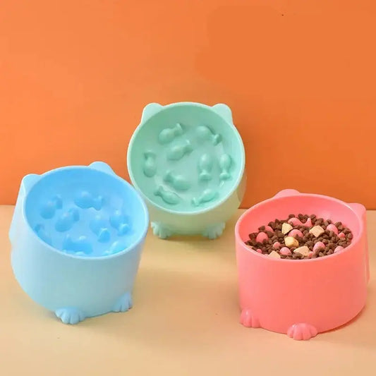 Three colorful pet food bowls shaped like cartoon animals.