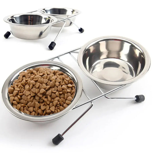 Stainless steel pet food bowls on raised stands with one bowl containing dry kibble.